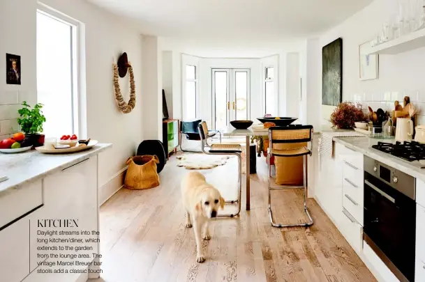  ??  ?? KITCHEN
Daylight streams into the long kitchen/diner, which extends to the garden from the lounge area. The vintage Marcel Breuer bar stools add a classic touch