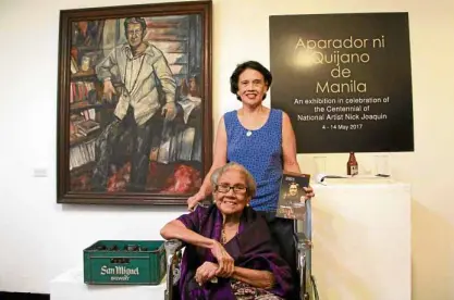  ?? —PHOTOS BY VINZ LAMORENA ?? Elena Roco (on wheelchair) and daughter Marissa before Danny Dalena’s portrait of Nick Joaquin and beside a case of San Miguel beer. Roco, a retired mathematic­s and Spanish professor at UST, was NJ’s “Muse” and beer buddy.