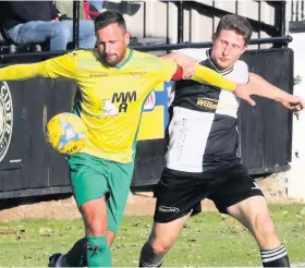  ?? Picture: Jason Bryant ?? Bitton’s Scott Brice comes under pressure from Shepton Mallet striker Joe Morgan during last Saturday’s Toolstatio­n League Premier Division game at West Shepton, which the hosts won 4-3