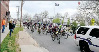  ?? Keith Bryant/The Weekly Vista ?? The approximat­ely 150 riders who showed up for the first Pedaler’s Bash race take off down the street with a police escort. The 45-mile race featured roughly 5,000 feet of elevation change and started at Pedaler’s Pub and went through portions of the...