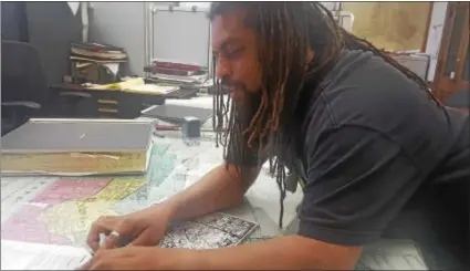  ?? ISAAC AVILUCEA — THE TRENTONIAN ?? Weed activist Ed Forchion pours over an outsized city zoning map Friday at City Hall.