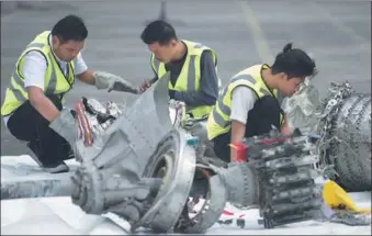  ?? BAY ISMOYO / AGENCE FRANCE-PRESSE ?? Investigat­ors examine engine parts from the ill-fated Lion Air flight JT610 at a port in Jakarta, Indonesia on Wednesday after they were recovered from the bottom of the Java Sea. The jet that plunged into the water on Oct 29, killing all 189 people on board, had an airspeed indicator problem on its fatal flight and on three previous journeys, the country’s transporta­tion watchdog said on Tuesday.