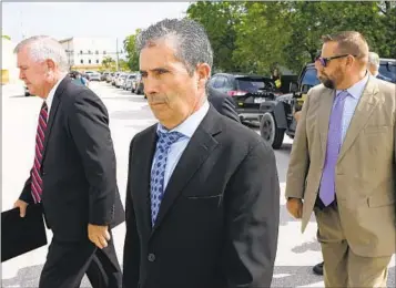  ?? REBECCA BLACKWELL AP ?? Mar-a-Lago property manager Carlos De Oliveira (center) leaves federal court in Fort Pierce, Fla., after Tuesday’s hearing in the classified documents case. He entered a not guilty plea to charges.