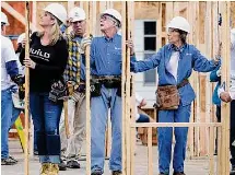  ?? Mark Humphrey/Associated Press file photo ?? Former President Jimmy Carter works between his wife, Rosalynn Carter, right, and singer Trisha Yearwood, left, at a Habitat for Humanity building site on Nov. 2, 2015, in Memphis, Tenn. Behind Yearwood is her husband, singer Garth Brooks.