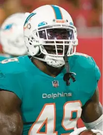  ?? JASON BEHNKEN/AP ?? Dolphins linebacker Sam Eguavoen celebrates after returning a fumble for a score during the first half of Saturday’s preseason game against the Buccaneers in Tampa.