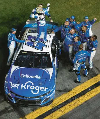  ?? SEAN GARDNER/GETTY ?? JTG Daugherty driver Ricky Stenhouse Jr., and his crew celebrate after winning the Daytona 500 on Sunday.