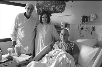  ?? COURTESY OF DR. KEITH EATON ?? Dr. Keith Eaton, who survived leukemia, poses for a photo with his parents following his bone marrow transplant. He says he ran up medical bills of $500,000 when he participat­ed in a clinical trial of CAR T cells in 2013, despite receiving the...