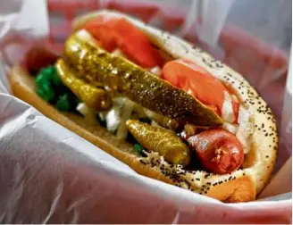  ?? PHOTOS BY LANE TURNER/GLOBE STAFF ?? Clockwise from top: Patrons enjoy lunch at Culinary Delights in Natick; the Chicago dog, one of the menu items at Culinary Delights; owner Alex Palterman.