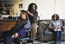  ?? Lianne Milton / Special to The Chronicle 2010 ?? Doris Campbell braids the hair of Annie Davis as Hawa Fallay waits at My African Heritage beauty shop in Vallejo.