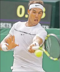  ?? AP PHOTO ?? Spain’s Rafael Nadal returns to Russia’s Karen Khachanov during their Men’s Singles Match on day five at the Wimbledon Tennis Championsh­ips in London Friday.