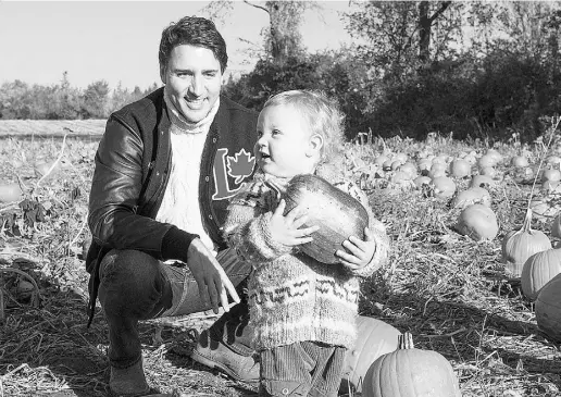  ?? PaulChiaso­n/TheCana dianPress ?? Liberal Leader Justin Trudeau picks pumpkins with his son Hadrien on Thanksgivi­ng Day in Gatineau, Que.