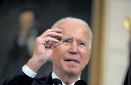  ?? Doug Mills, © The New York Times Co. ?? President Joe Biden holds a semiconduc­tor in Feburary at the White House. Shortages of semiconduc­tors, fueled by pandemic interrupti­ons and production issues at factories, have sent shock waves through the economy.