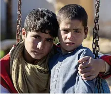  ?? Picture: STEVE REIGATE ?? Saved...Afghan teen Mohammad with little brother Ahmad