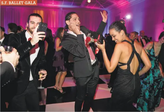  ?? Laura Morton / Special to The Chronicle ?? Artem Kevorkov (left), Tony Abello and Sekina Abbas enjoy one of the dance floors at City Hall during the after-party following the Ballet’s Opening Night Gala.