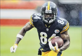  ?? Ron Schwane / Associated Press ?? Pittsburgh Steelers wide receiver Antonio Brown runs with the ball against the Cleveland Browns during the first half of an NFL football game Sept. 9 in Cleveland. Brown caused a stir when he responded to a critic online by daring the Steelers to trade him.