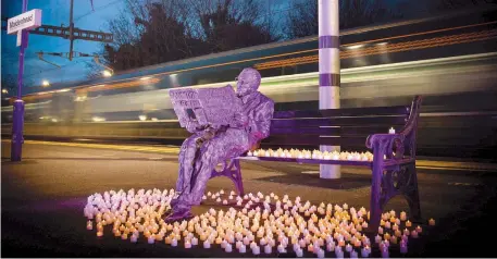  ?? Photo by GWR/Simon Galloway ?? GWR marks Holocaust Memorial Day by placing candles around the statue of Sir Nicholas Winton at Maidenhead Station.