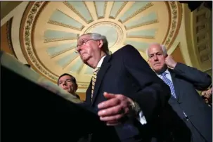  ?? The Associated Press ?? MCCONNELL: Senate Majority Leader Mitch McConnell, of Ky., center, with Senate Majority Whip John Cornyn of Texas, right, and Sen. John Barrasso, R-Wyo., talks to reporters Tuesday on Capitol Hill in Washington. Weary Republican­s in Washington may be...