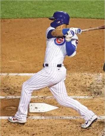  ?? JONATHAN DANIEL/GETTY IMAGES ?? Willson Contreras hits a two-run single in the first inning Friday night against the Cardinals.