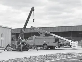  ?? OKLAHOMA GAS AND ELECTRIC CO. ?? An electric-powered bucket truck and crane are displayed at Oklahoma Gas and Electric Co.’s Advanced Technologi­es Laboratory.