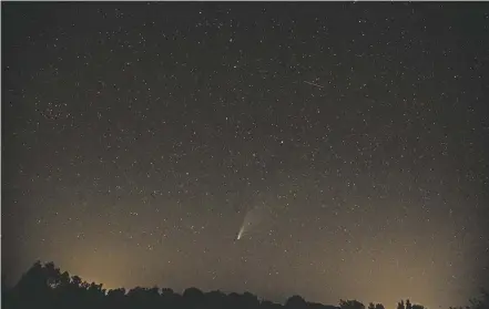  ?? PHOTOS COURTESY ADRIANA REYES NEWELL ?? ABOVE: Adriana Reyes Newell, a Los Alamos physicist and profession­al photograph­er shot an image of NEOWISE comet. TOP: A meteor breaks up over Santa Fe on Tuesday night.