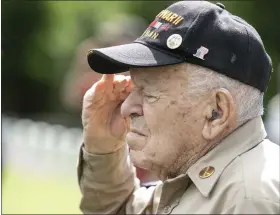  ?? ?? Saluting during the playing of the national anthem is World War II veteran Joe Landry from Shirley.