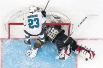  ?? JOHN LOCHER/THE ASSOCIATED PRESS ?? Vegas Golden Knights goalie Marc-Andre Fleury gets a visit from San Jose Sharks right winger Barclay Goodrow on Saturday.