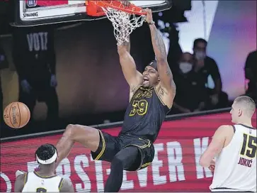  ?? Mark J. Terrill Associated Press ?? DWIGHT HOWARD dunks over Denver’s Jerami Grant and Nikola Jokic in the first half of Game 2 of the Western Conference finals. The Lakers, with a 2-0 series lead, are just two wins away from the NBA Finals.