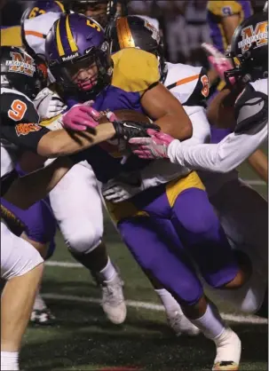  ?? The Sentinel-Record/Corbet Deary ?? ON THE RUN: Fountain Lake’s Andrew Roberson plows for yardage against Malvern defenders Brandon Scott (9) and Latron Matlock, right, in Friday night’s game on Allen Tillery Field at Beckham Memorial Stadium. Malvern built a 22-2 halftime lead over the...