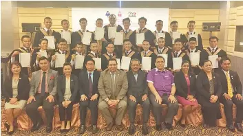  ??  ?? Osman (seated fifth left) and Abdul Razak (seated sixth left) with graduates and Ascot Academy personnel at the graduation ceremony yesterday.