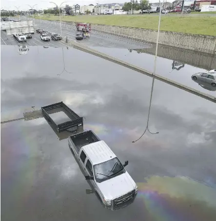  ?? ED KAISER ?? City officials are checking into whether flooding under the overpass on Whitemud Drive was caused by a blockage in drainage pipes or a lack of capacity to handle the heavy rainfall.