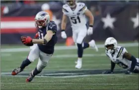  ?? CHARLES KRUPA —THE ASSOCIATED PRESS ?? Patriots wide receiver Julian Edelman runs after catching a pass against the Chargers during the second half of a playoff football game Jan. 13, in Foxborough, Mass.