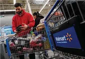  ?? Eduardo Munoz Alvarez/Associated Press ?? Economists find Americans, like Francisco Santana of North Bergen, N.J., are still spending, albeit more cautiously, as inflation remains stubbornly high.