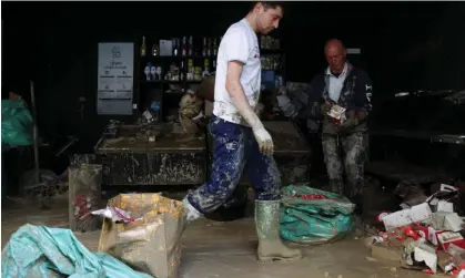  ?? Photograph: Claudia Greco/Reuters ?? People clean up debris at a coffee shop in Faenza, Italy.