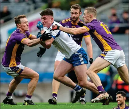  ?? ?? SURROUNDED: Alex Beirne of Naas is tackled by Kilmacud duo Shane Cunningham and Paul Mannion