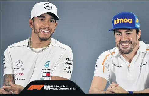  ??  ?? Mercedes’ Lewis Hamilton, left, and McLaren’s Fernando Alonso during a press conference in Abu Dhabi.