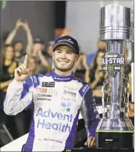  ?? Chuck Burton / Associated Press ?? Kyle Larson poses with the trophy after winning the Monster Energy NASCAR Cup Series All-Star Race at Charlotte Motor Speedway on Saturday night in Charlotte, N.C.