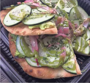  ?? MILWAUKEE JOURNAL SENTINEL ?? A version of avocado toast on the changing menu in summer at Hello Falafel, 2301 S. Howell Ave., on flatbread with cucumber and pickled onion.