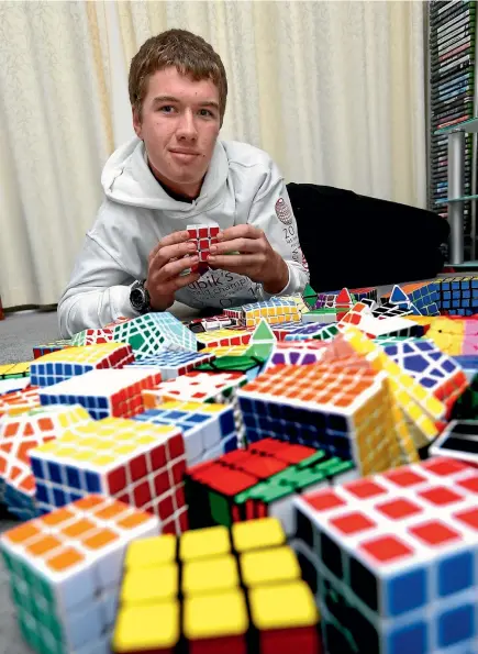  ??  ?? You could spend hours trying to solve the Rubik’s cube (unless you are a champ like Alex Asbery, above) but try telling that to the young people of today.
