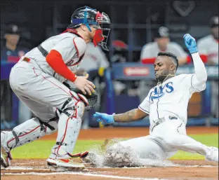  ?? Chris O’meara The Associated Press ?? Randy Arozarena scores past Red Sox catcher Christian Vazquez on Wander Franco’s first-inning double Thursday in the Rays’ 5-0 win at Tropicana Field.