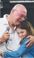  ??  ?? GOOD WORK: Member for Leichhardt Warren Entsch hugs Cairns student Molly Steer who led a Straw No More campaign.