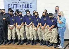  ?? [CARLA HINTON/ THE OKLAHOMAN] ?? Oklahoma City Police Chief Wade Gourley poses for a photo with members of the police department's Cadet Program after the “Faith & Blue Weekend” community forum Saturday at St. James the Greater Catholic Church in south Oklahoma City.