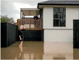  ??  ?? Hayley, left, and Sharleen Sorensen survey the rising floodwater­s around their Opawa Rd, Christchur­ch, home.