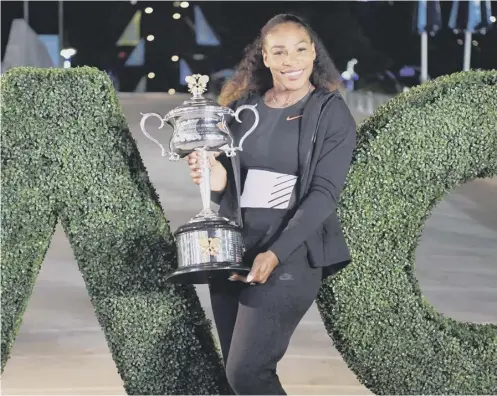  ??  ?? Serena Williams with the trophy after her victory against sister Venus in the 2017 Australian Open women’s singles final in Melbourne.