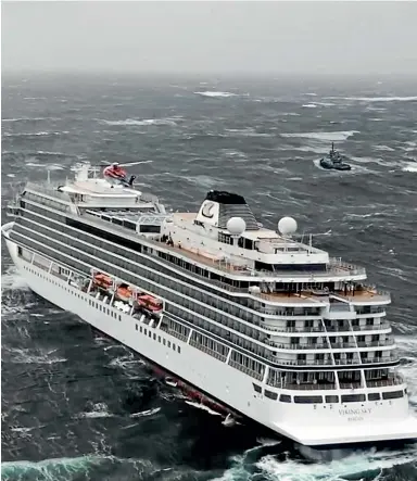  ??  ?? A helicopter flies over the cruise ship Viking Sky after it sent out a Mayday signal because of engine failure in windy conditions off the west coast of Norway.