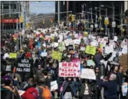  ?? CRAIG RUTTLE — THE ASSOCIATED PRESS ?? People taking part in a march against gun violence walk along 6th Avenue in New York Saturday, March 24, 2018.