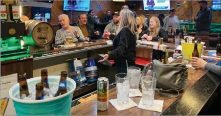  ?? PHOTOS BY MITCH HOTTS — THE MACOMB DAILY ?? Veteran Rusty Nail bartender Lori Mac keeps the crowd well hydrated and fed on a recent afternoon. The staff looks forward to having a larger kitchen when they move to their new location.