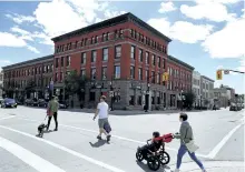  ?? CLIFFORD SKARSTEDT/EXAMINER ?? Pedestrian­s cross Water and Hunter streets opposite the building that houses St. Veronus on June 2. The building and the two adjoining it have a long, interestin­g history, Elwood Jones writes this week.