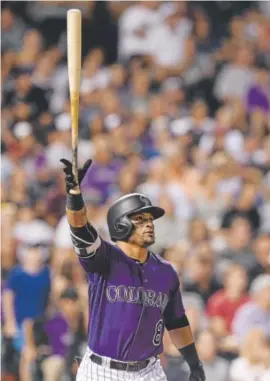  ?? Dustin Bradford, Getty Images ?? Colorado’s Gerardo Parra holds the bat aloft as he watches the ball soar over the fence in the fifth inning. The solo homer helped lift the Rockies to an 8-4 win over Milwaukee.
