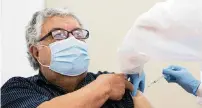  ?? SAM NAVARRO Special for the Miami Herald ?? Eduardo Barton, 70, receives a dose of a COVID-19 vaccine from medical assistant Lorend Pinedo, 29, at Leon Medical Centers, 7950 NW Second St., on Thursday.