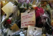  ?? PHOTO: RAUL ROA/LOS ANGELES TIMES ?? A note is attached to flowers left for the 11shooting victims at the memorial site in front of Star Ballroom Dance Studio on Jan. 26 in Monterey Park.
